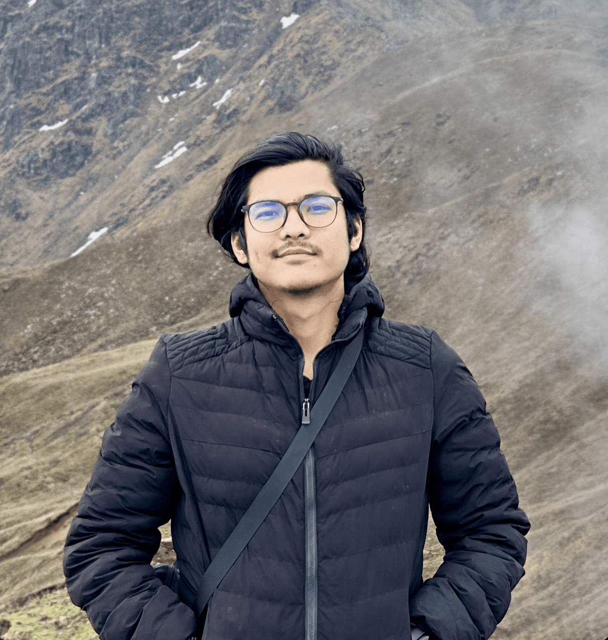 Kunal Shrestha standing in front of a mountain landscape